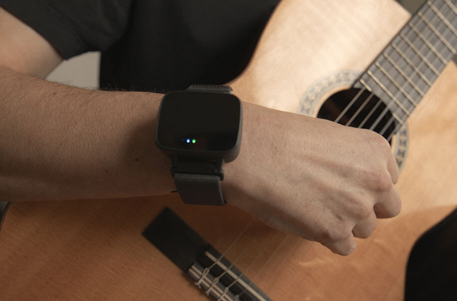 Person using their hands steadily while wearing the Felix wristband
