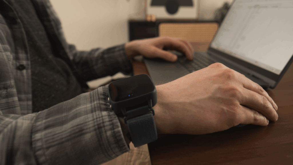 Individual working seamlessly while wearing the Felix NeuroAI wristband